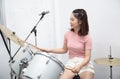 Portrait of young beautiful asian woman playing drums in music studio. She loves and enjoy playing on instruments.Concept of art, Royalty Free Stock Photo