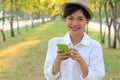 Portrait of young beautiful asian woman and smart phone in hand Royalty Free Stock Photo