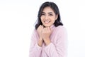 Portrait of young beautiful Asian woman smiling friendly wearing pink winter knitted and looking at camera against isolated white Royalty Free Stock Photo