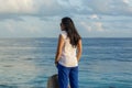 Portrait of a young beautiful asian woman thinking near ocean Royalty Free Stock Photo