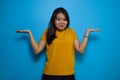 Portrait of Young beautiful asian women wearing yellow shirt with blue isolated background Royalty Free Stock Photo