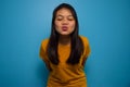 Portrait of Young beautiful asian women wearing yellow shirt with blue isolated background Royalty Free Stock Photo