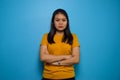 Portrait of Young beautiful asian women wearing yellow shirt with blue isolated background Royalty Free Stock Photo