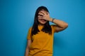 Portrait of Young beautiful asian women wearing yellow shirt with blue isolated background Royalty Free Stock Photo