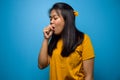 Portrait of Young beautiful asian women wearing yellow shirt with blue isolated background Royalty Free Stock Photo