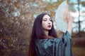 Portrait of young beautiful Asians in grey kimono and with a fan Royalty Free Stock Photo