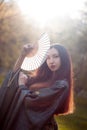 Portrait of young beautiful Asians in grey kimono and with a fan Royalty Free Stock Photo