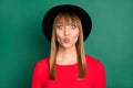 Portrait of young beautiful attractive pretty charming girl in big black hat pout lips isolated on green color Royalty Free Stock Photo