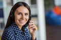 Portrait of young beautiful attractive smiling cheerful good mood businesswoman in headphones working at call center Royalty Free Stock Photo