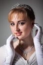 Portrait of young beautiful blond ballerina woman in white tutu, gloves and jewelry Royalty Free Stock Photo