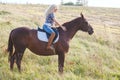 Portrait of young beautiful blond hair woman riding horse. Travel with animal Royalty Free Stock Photo