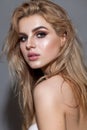 Portrait of young beautiful blond model with a day professional make up and perfect bright skin.