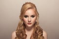 young beautiful blond woman. Hairstyle and make-up.