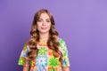 Portrait of young beautiful blonde curly hair girl wearing flowers print t shirt support peace hippie on violet