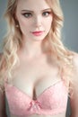 Portrait of young beautiful blonde woman wearing a bra. Close up retouched portrait. Royalty Free Stock Photo