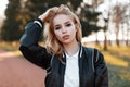 Portrait of a young beautiful blonde woman in a fashionable light black jacket in a stylish white shirt