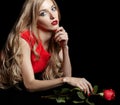 Portrait of young beautiful blonde woman in red dress with red r Royalty Free Stock Photo