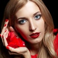 Portrait of young beautiful blonde woman in red dress with red r Royalty Free Stock Photo