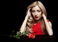 Portrait of young beautiful blonde woman in red dress with red r Royalty Free Stock Photo