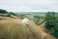 Portrait of a young beautiful bride on a background of a gorgeous view of the river and fields. Royalty Free Stock Photo