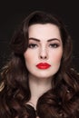 Portrait of beautiful brunette with curly hair and red lipstick Royalty Free Stock Photo