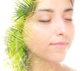 A double exposure portrait of a beautiful brunette with her eyes closed and palm tree leaves against white background Royalty Free Stock Photo