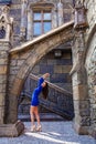 Portrait young beautiful brunette woman in blue dress posing against the backdrop of an old castle in the Gothic style Royalty Free Stock Photo