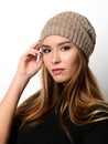 Portrait of young beautiful brunette woman posing in gray winter hat Royalty Free Stock Photo