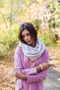 Portrait of a young beautiful brunette woman on the street, autumn afternoon in warm seasonal clothes, women`s urban street Royalty Free Stock Photo