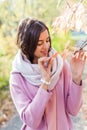 Portrait of a young beautiful brunette woman on the street, autumn afternoon in warm seasonal clothes, women`s urban street Royalty Free Stock Photo