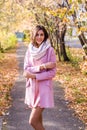 Portrait of a young beautiful brunette woman on the street, autumn afternoon in warm seasonal clothes, women`s urban street Royalty Free Stock Photo