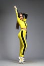 Portrait of a young beautiful brunette woman in yellow tracksuit Royalty Free Stock Photo