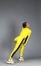 Portrait of a young beautiful brunette woman in yellow tracksuit Royalty Free Stock Photo