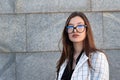 Portrait of young beautiful business woman in glasses. Serious lady