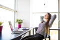 Portrait of young beautiful business woman relaxing at office. Royalty Free Stock Photo