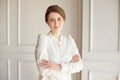 Portrait of a young beautiful business woman in a white shirt and black pants with a hairstyle a sheaf of brunette in Royalty Free Stock Photo