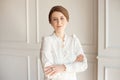 Portrait of a young beautiful business woman in a white shirt and black pants with a hairstyle a sheaf of brunette in Royalty Free Stock Photo