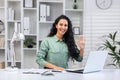 Portrait of young beautiful business woman at workplace inside office, Hispanic woman smiling and looking at camera Royalty Free Stock Photo