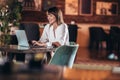 Young beautiful businesswoman enjoying coffee during work on portable laptop computer Royalty Free Stock Photo