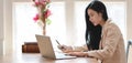 Portrait of young beautiful businesswoman working on her project with laptop computer in comfortable office Royalty Free Stock Photo