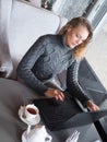 Portrait of a young beautiful businesswomen enjoying coffee during work on portable laptop computer, charming female Royalty Free Stock Photo