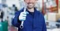 Portrait of a young beautiful car mechanic in a car repair shop, hands with a spanner. Concept: repair of machines, fault diagnosi Royalty Free Stock Photo