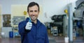 Portrait of a young beautiful car mechanic in a car workshop, in the background of service. Concept: repair of machines, fault dia Royalty Free Stock Photo