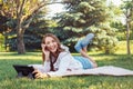 Caucasian teenage girl talking over cell mobile phone outside in park Royalty Free Stock Photo