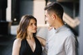 Portrait of a young beautiful couple. The girl looks into the eyes of her loved one and smiles. First date and the concept of Royalty Free Stock Photo