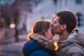 Portrait of young beautiful couple kissing in an autumn rainy day. Royalty Free Stock Photo