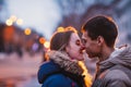 Portrait of young beautiful couple kissing in an autumn rainy day. Royalty Free Stock Photo