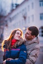 Portrait of young beautiful couple kissing in an autumn rainy day. Royalty Free Stock Photo