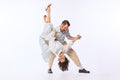 Portrait of young beautiful couple, man and woman, dancing tango isolated over white studio background. Romantic Royalty Free Stock Photo