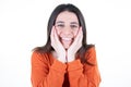 Portrait of young beautiful cute cheerful girl smiling looking at camera hands on face chin over white background Royalty Free Stock Photo